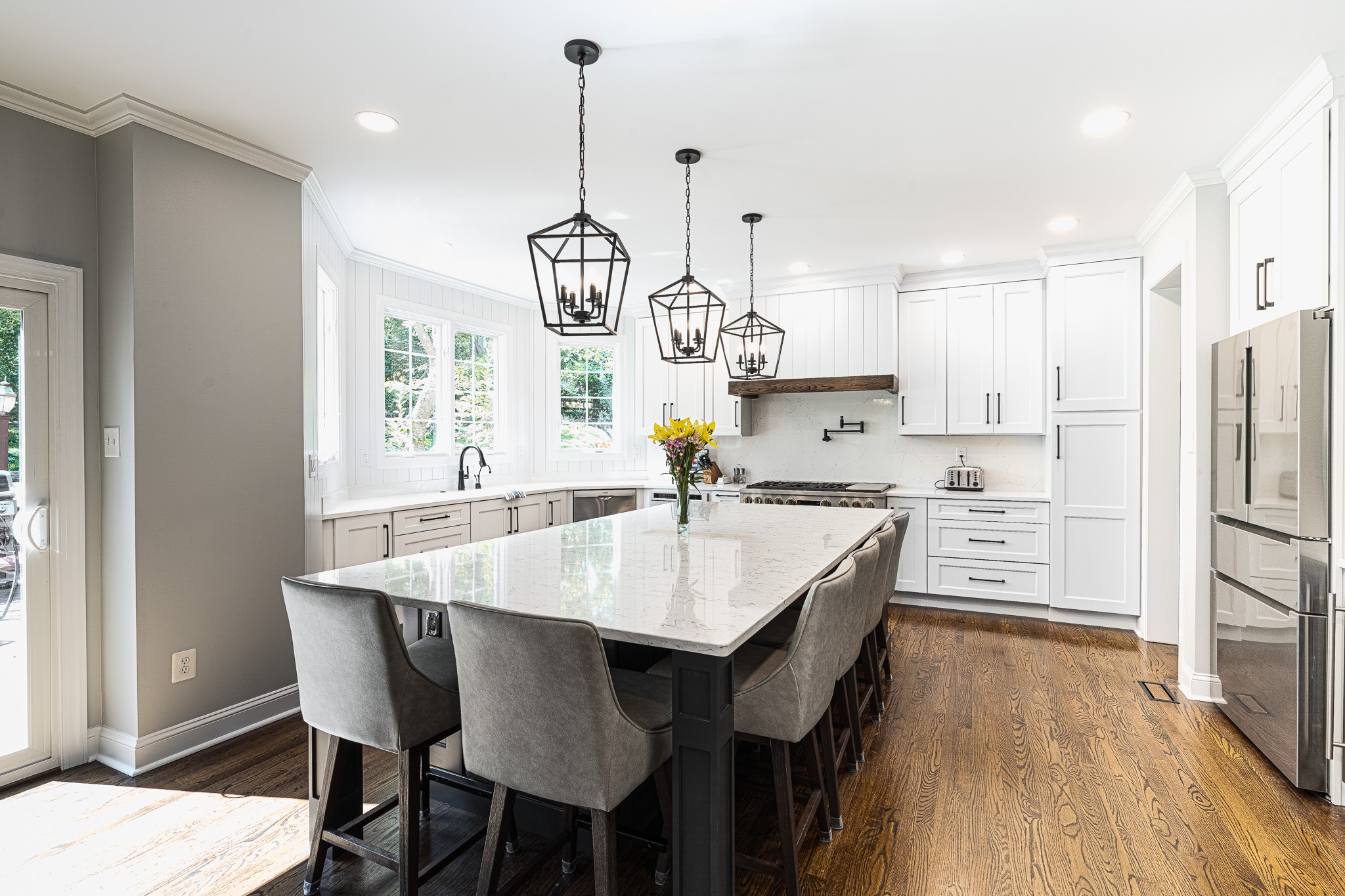 LBK 2024 CotY award kitchen remodel older home layout reconfigured, mixed quartz & shiplap backsplash, warm wood flooring