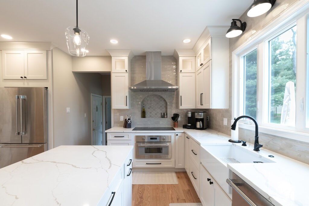 Kitchen and master bath remodel in Doylestown with white cabinets, black hardware, and textured backsplash tile.